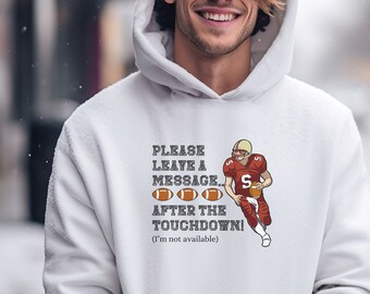May include: White hoodie with a football player graphic and the text "PLEASE LEAVE A MESSAGE. 0000 AFTER THE TOUCHDOWN! (I'm not available)"