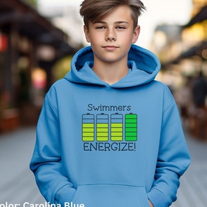 May include: A blue hooded sweatshirt with the text "Swimmers Energize!" and a graphic of five battery icons with different levels of charge.