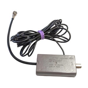 May include: A grey Nintendo RF Switch with black cables and a silver connector. The cables are secured with a purple rubber band. The device has text that reads "Nintendo RF Switch" and "Model NO. NES-003".