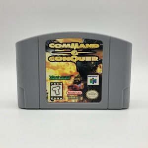 May include: A gray Nintendo 64 game cartridge for Command & Conquer, featuring a green Westwood Studios logo and a Teen rating from the ESRB.