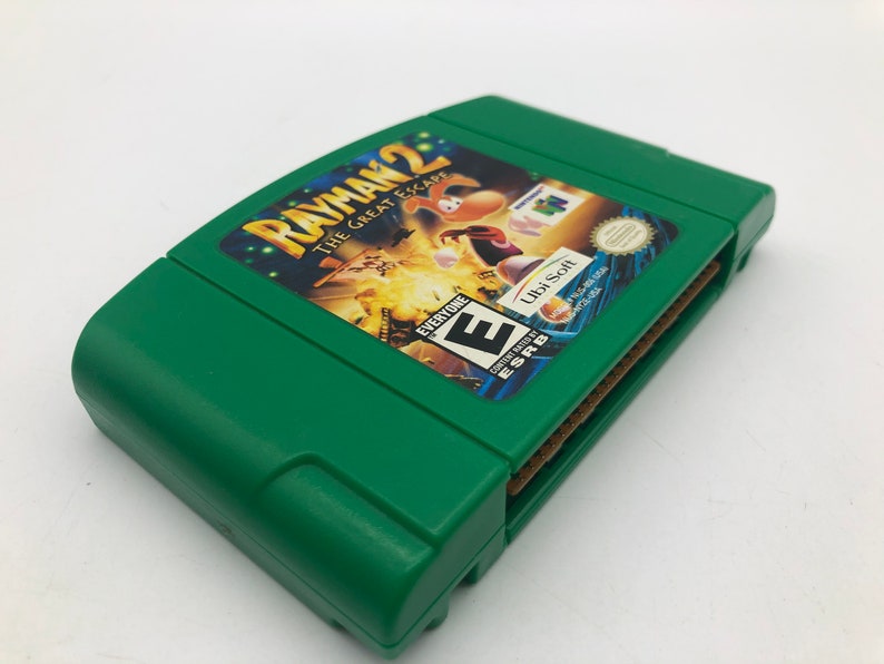 May include: Green Nintendo 64 game cartridge for Rayman 2: The Great Escape. The game is rated E for Everyone by the ESRB. The game is published by Ubi Soft.