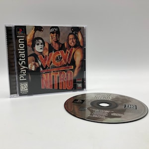 May include: A PlayStation game case with a black background and the text "WCW Nitro" in red and yellow. The front of the case features three wrestlers, including "Hollywood" Hulk Hogan, in a wrestling pose. The game is rated "KA" by the ESRB.