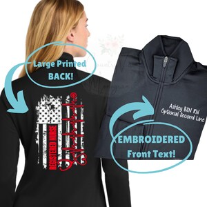 May include: Black zip-up jacket with a large printed design on the back featuring an American flag, a heartbeat line, and the words "REGISTERED NURSE" in red. The front has embroidered text: "Ashley BSN RN Optional Second Line."