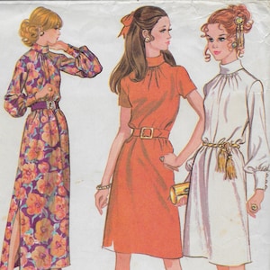 May include: Vintage McCall's sewing pattern 2667 featuring three Misses' dress designs. The pattern envelope shows illustrations of dresses in floral, orange, and white fabrics. The dresses have various sleeve lengths and belt styles. The envelope is yellow and white.
