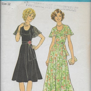 May include: A sewing pattern for two dresses. The first dress is black with a sheer overlay and a sash. The second dress is green with a floral print and a sash. The pattern number is 7382 and the price is $1.50.