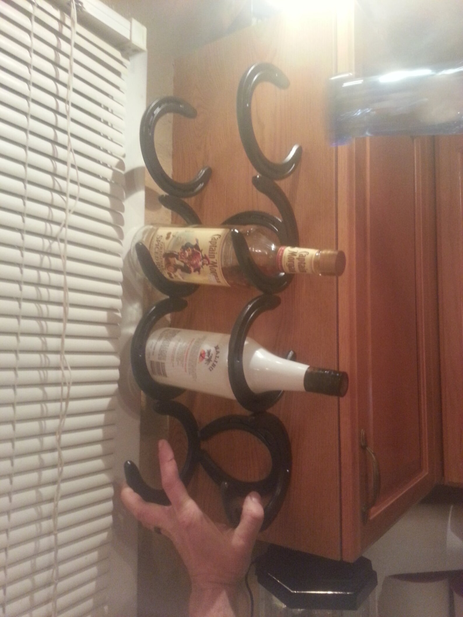 Horseshoe Wine Rack Holds Four Bottles and is Made to Go on Etsy