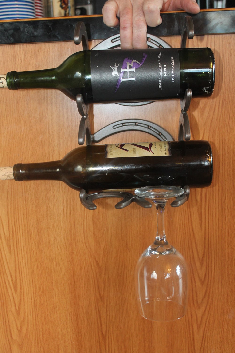 Horseshoe wine rack mounts to wall holds to glasses and bottles