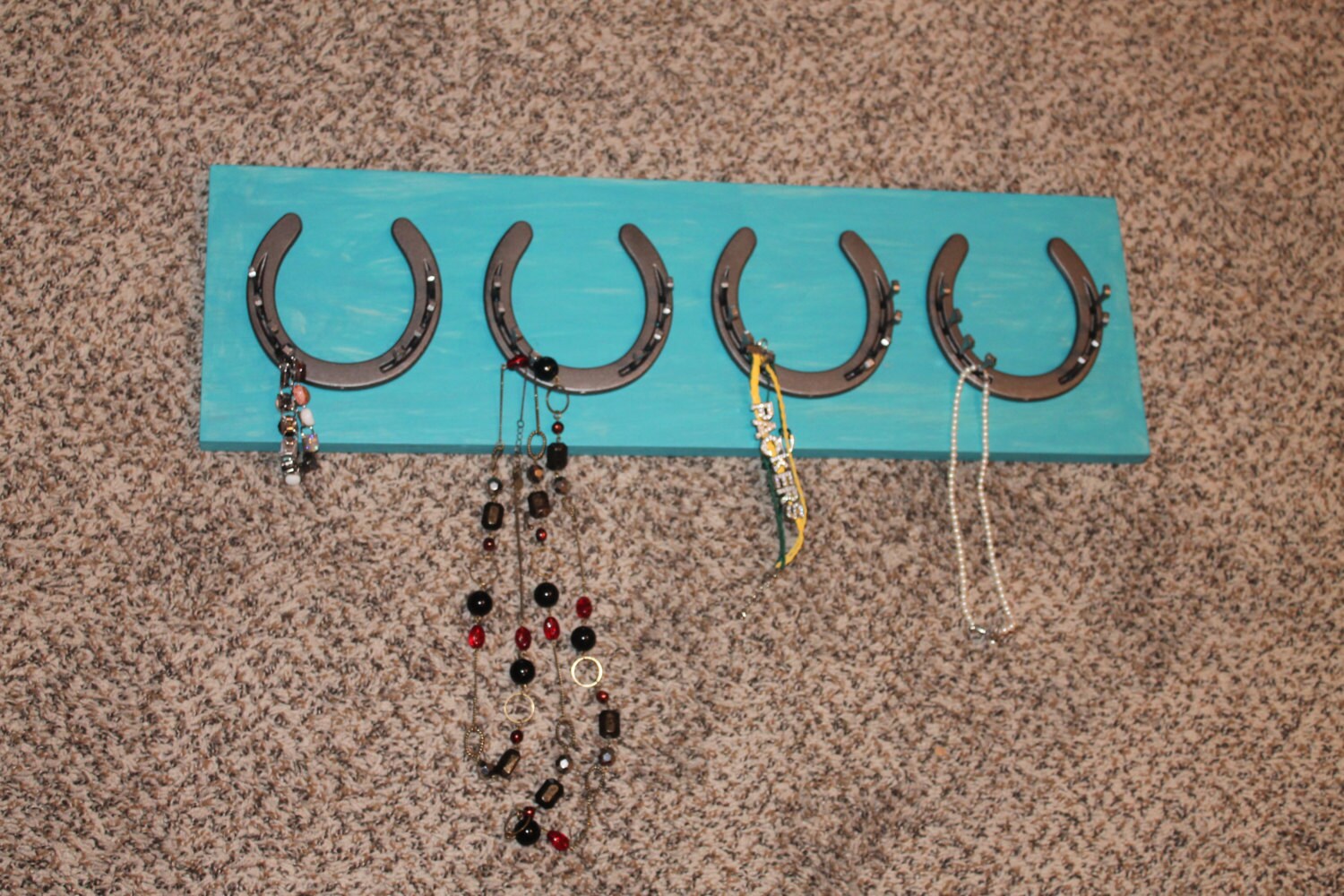 Horseshoe jewelry holder