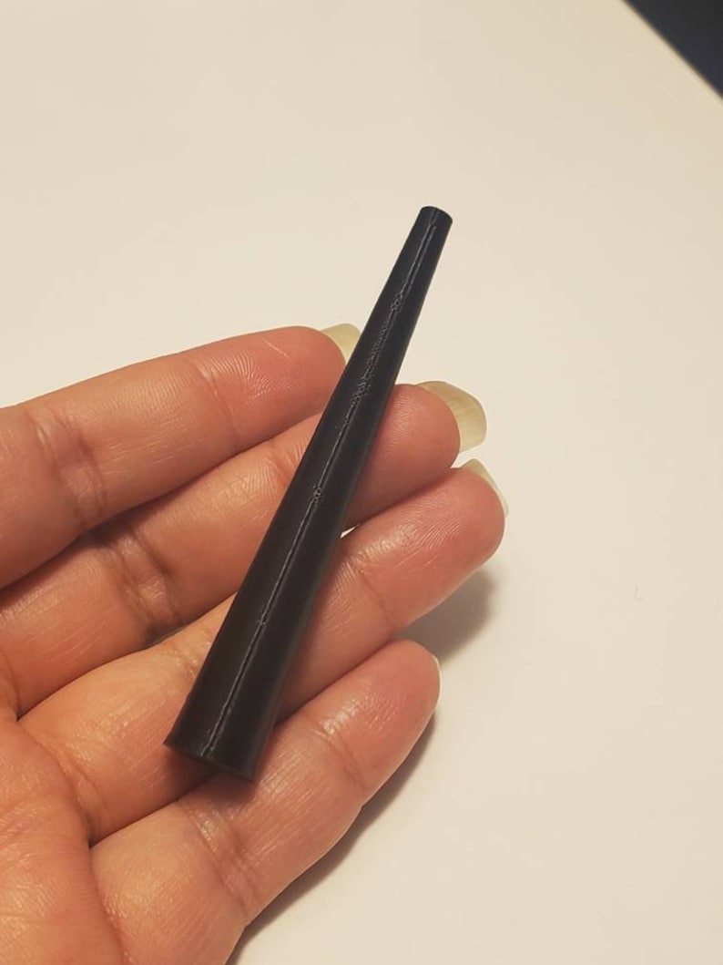May include: A black, tapered, plastic cone-shaped object.