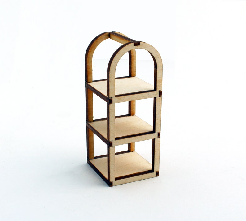 May include: A wooden shelf unit with three shelves and an arched top. The shelf unit is made of light brown wood and has a natural finish.