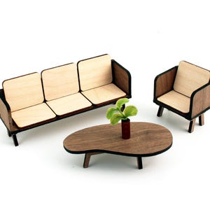May include: A wooden miniature living room set with a three-seater sofa, a single armchair, and a coffee table. The furniture is made of light and dark wood with a natural finish. A small green plant sits on the coffee table.