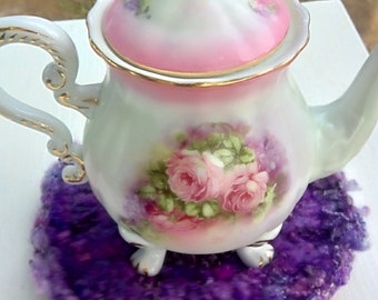 Purple Wool Trivet crocheted in the round with hand spun yarn.  A gray flowered button is in the center, made by hand, kitchen, diningroom,