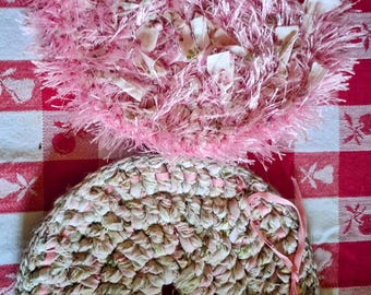 2 potholders made with crocheted fabric.  One has eyelash yarn and fabric crocheted together.  The other one is edged with homespun wool.