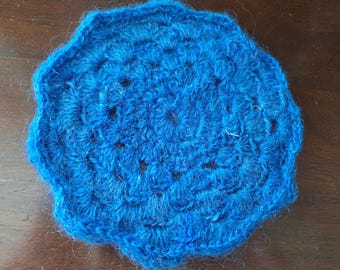 A little blue sparkling trivet is crocheted with sparkling handspun yarn.  This trivet will add a little spark to a table under a teapot ...