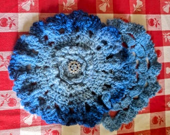 2  Blue handspun crocheted trivets with fancy sparkling buttons in the center.  Stunning as a center piece.  Put under a teapot or dish.