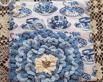 Set of 2 adorable potholders, One potholder is crocheted in a flower and one has fabric with teacups and backed with recycled denim.