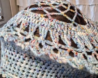Blue tweed colored crocheted hat with merino wool yarn.  The top is partially open with a lace look.  A lace pannel is on the side.