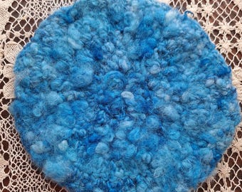 Pretty bright blue crocheted trivet.  This is made from extra fluffy handspun yarn which is made from a Golf Coast Native X Romney sheep.