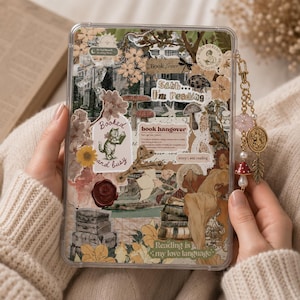 Op de afbeelding: Een doorzichtige beschermhoes voor e-readers met een collage van vintage illustraties, waaronder een lezende kat, paddenstoelen, stapels oude koffers en tekstelementen zoals "Shhh... I'm reading" en "Reading is my love language."