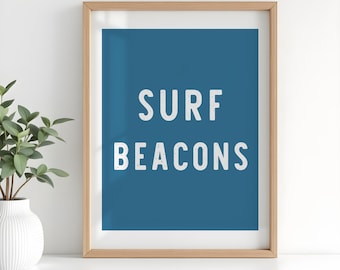 May include: A framed print with a blue background and white text that reads "SURF BEACONS".
