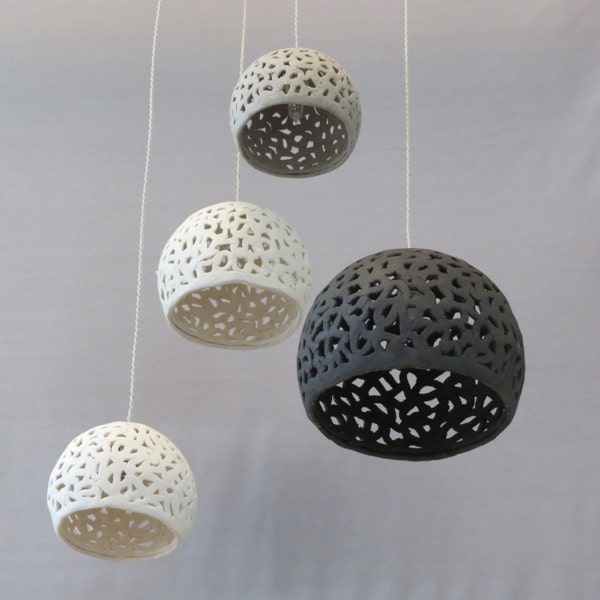 4 white, gray and black ceramic pendants. Different size spheres. Ceiling lamp. Hanging chandeliers.