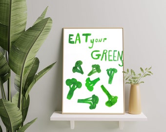 May include: A framed print with the text "EAT your GREENS" in green handwritten font. The print features a white background with green watercolor illustrations of broccoli florets.