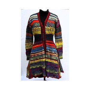 May include: A long, multi-colored knitted coat with a black waist belt and a flared skirt. The coat features a V-neck and long sleeves. The color palette includes red, yellow, blue, and purple, creating a vibrant, textured appearance.