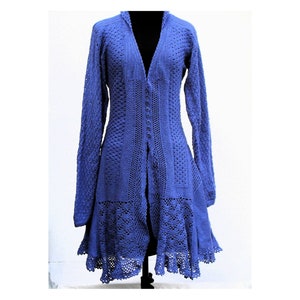 May include: A long, open-front blue cardigan with a unique, textured knit design. The cardigan features long sleeves, a V-neck, and a flared skirt with a scalloped hem. It is displayed on a black mannequin.