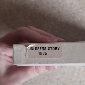 May include: A white box with a white label that says "Childrens Story 1975".