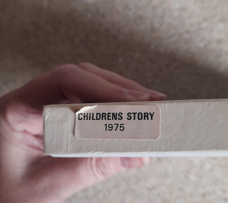 May include: A white box with a white label that says "Childrens Story 1975".