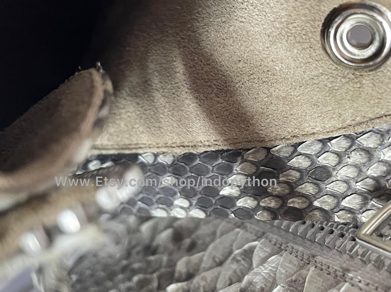 May include: Close-up of a beige suede bag with a silver metal zipper and a silver metal snap closure. The bag is lined with a gray and white snakeskin pattern. The text "www.Etsy.com/shop/indopython" is visible on the lining.