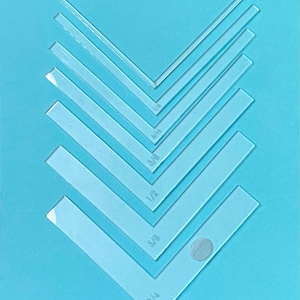 May include: Set of eight clear plastic rulers with different measurements: 1/4, 3/4, 5/8, 1/2, 3/8, 1/4, 1/8, and 1/16 inches.