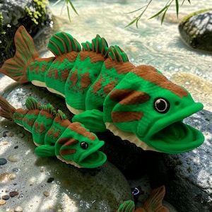 May include: Three articulated fish figurines in varying sizes, each featuring a vibrant green body with brown patterned markings, textured scales, prominent dorsal fins, and open mouths with visible eyes, crafted with a segmented design.