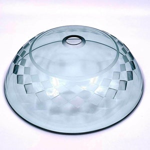 May include: A clear glass bowl with a frosted, geometric pattern. The bowl has a rounded shape and a slightly raised rim.