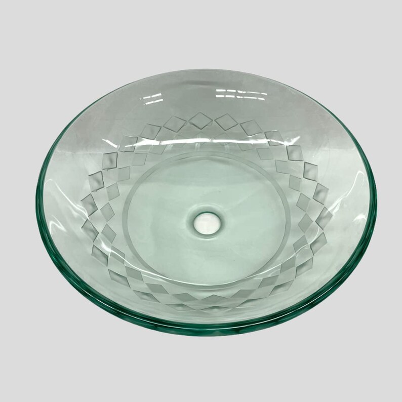 May include: A clear glass sink with a diamond pattern etched into the surface. The sink has a single drain hole in the center.