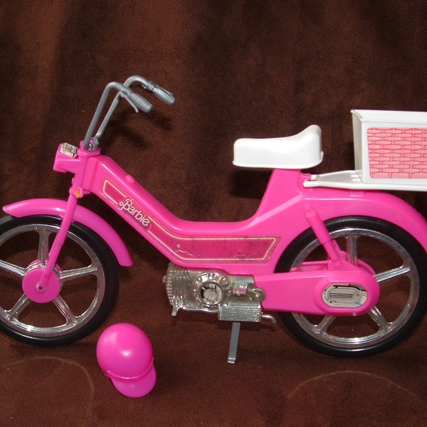 Barbie's 1983 moped is ready to roll.  It's pink of course and includes her helmet and rear basket.  Excellent condition, great mileage!