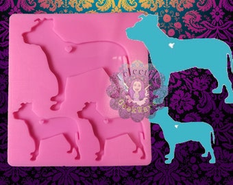 May include: Pink silicone mold with three dog shapes. The mold is for making resin or polymer clay dog charms. The largest dog is in the top right corner of the mold. The two smaller dogs are in the bottom left corner of the mold.