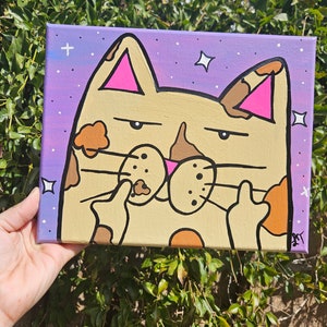 May include: A hand-painted canvas featuring a cartoon cat with brown spots and pink ears. The cat is giving the middle finger with both hands. The background is a purple and white galaxy with stars.