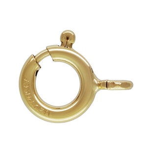 May include: Gold-toned metal spring ring clasp with a round opening. The clasp is marked "14K 1/20 12.0" on the side.