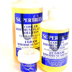 May include: Three bottles of SuperBrite rhodium plating solution. The bottles have white caps and blue labels with white text. The largest bottle contains 1 gram of rhodium metal. The smallest bottle is labeled "Pen Pals".