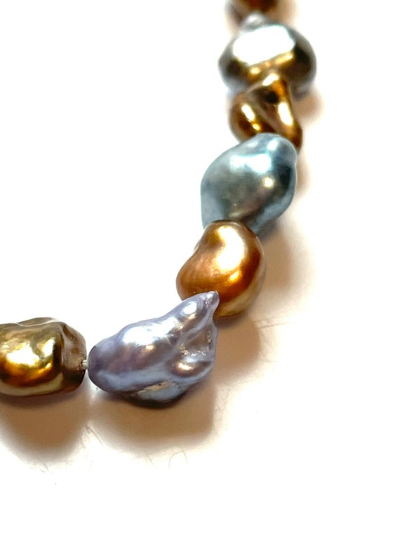 Beautiful mixed ocean blue, chocolate brown and lovely purple Tahitian Keshi pearl strand, 100% enhanced