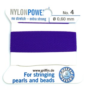 May include: Purple nylon string for stringing pearls and beads. The string is on a white card with the text "Nylon Power No. 4 no stretch - extra strong Ø 0,60 mm" and "www.griffin.de Griffin since 1866 Germany For stringing pearls and beads".