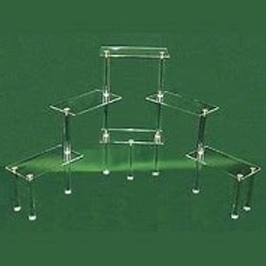 May include: Set of five clear acrylic display risers of varying sizes. The risers are rectangular and have a modern, minimalist design.