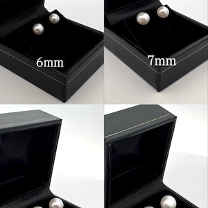 May include: Four black jewelry boxes, each displaying a pair of white pearls. The boxes are labeled with pearl sizes: 6mm, 7mm, 8mm, and 9mm. The pearls are set against a black velvet interior.