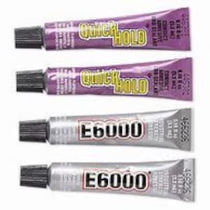 May include: Four tubes of adhesive glue. Two tubes are purple and labeled "Quick Hold" and two tubes are silver and labeled "E6000".