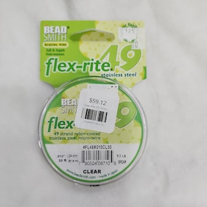 May include: A clear spool of Bead Smith Flex-Rite 49 strand nylon-coated stainless steel micro-wire. The spool is labelled with the product name, price, and size. The wire is 0.010 inches (0.24 mm) thick and has a 9.3 lb break strength. The spool is 30 feet (9.14 metres) long.