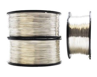 May include: Two spools of silver wire, one full and one partially unwound, with black plastic spools.