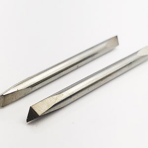May include: Two silver-colored, pointed tools with a slightly rounded tip. The tools are about 6 inches long.