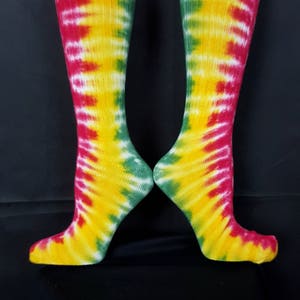 May include: A pair of knee-high socks with a tie-dye pattern in red, yellow, and green.
