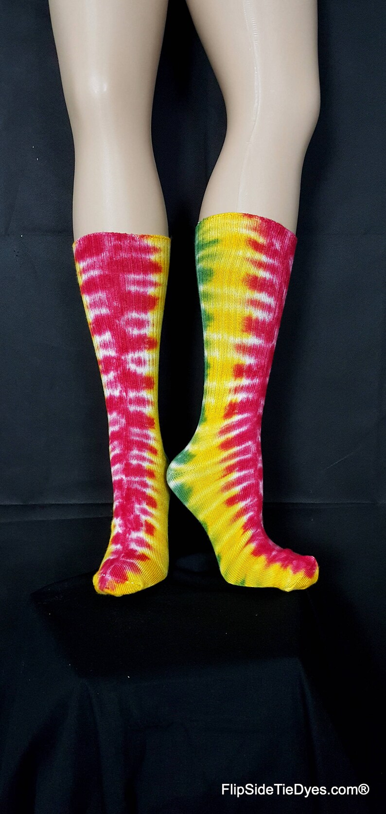 May include: A pair of colorful tie-dye socks in red, yellow, and green. The socks are made of a soft, comfortable material and are perfect for adding a pop of color to any outfit.